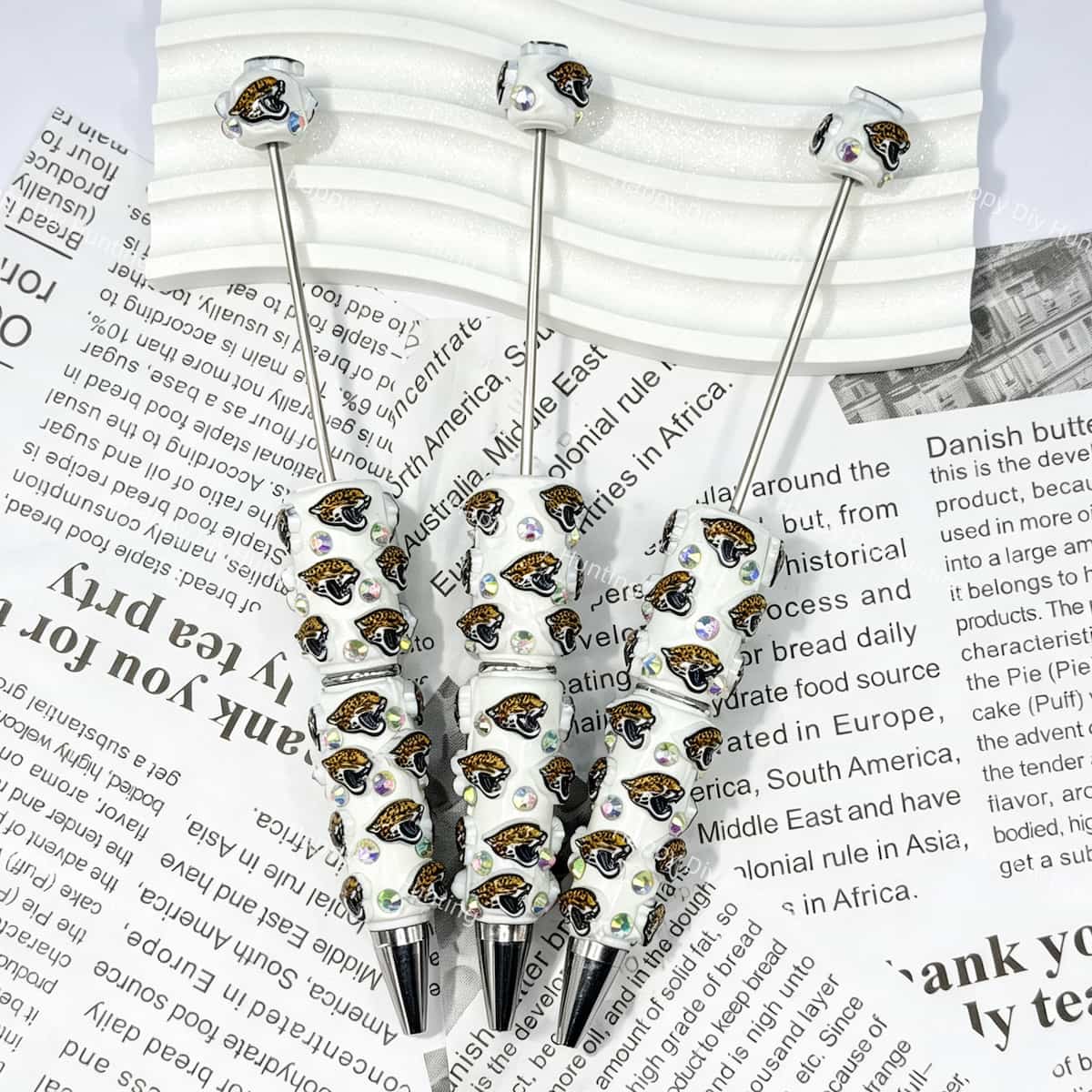 close-up green-black wildcat JJ football beadable pen showing wildcat design and beadable barrel