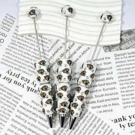 close-up green-black wildcat JJ football beadable pen showing wildcat design and beadable barrel