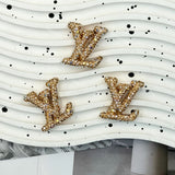 Metallic gold with AB iridescent rhinestone LV charm for luxury‑style DIY craft supplies.