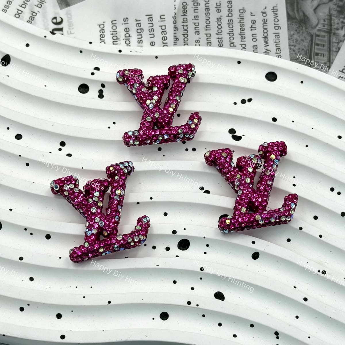 Vibrant magenta with AB iridescent rhinestone LV charm for handmade craft projects.