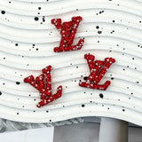Red base with white crystal rhinestone LV charm for handmade stationery and hair accessories.