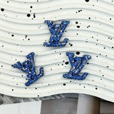 Light sky‑blue AB glitter LV shape charm for DIY pen, hair clip and resin crafts.