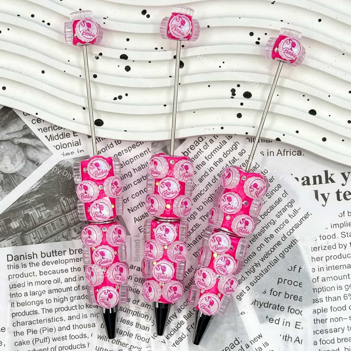 close-up pink bottle cap cartoon character beadable pen showing cute figurine design and pen topper fit
