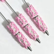 close-up pink bow print beadable pen showing bow design and beadable barrel