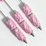 close-up pink bow print beadable pen showing bow design and beadable barrel