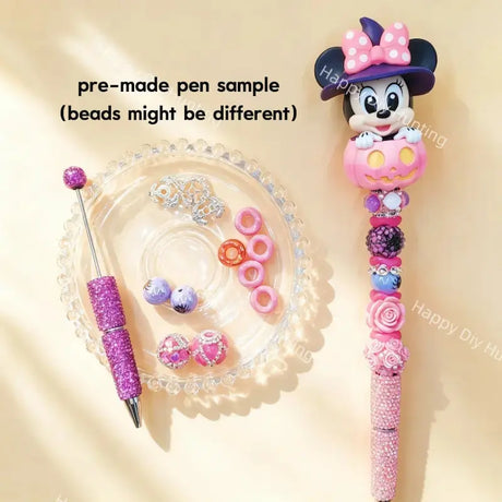 Pre-made beaded pen featuring a cute cartoon girl mouse with a witch hat emerging from a pink Halloween pumpkin topper, styled with pink and purple glitter beads.