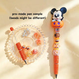 Pre-made beaded pen featuring a cute cartoon boy mouse emerging from a Halloween pumpkin topper, styled with orange rhinestone beads and holiday accessories.