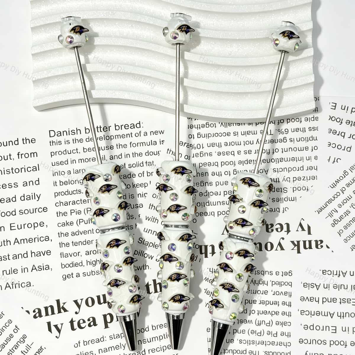 close-up purple-black raven bird BR football beadable pen showing raven design and beadable barrel