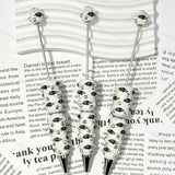 close-up purple-black raven bird BR football beadable pen showing raven design and beadable barrel