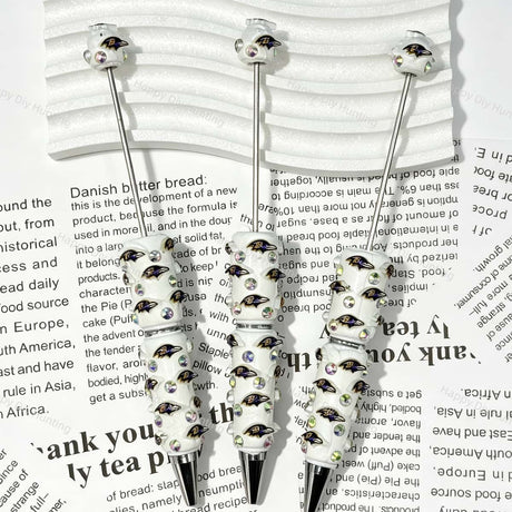 close-up purple-black raven bird BR football beadable pen showing raven design and beadable barrel