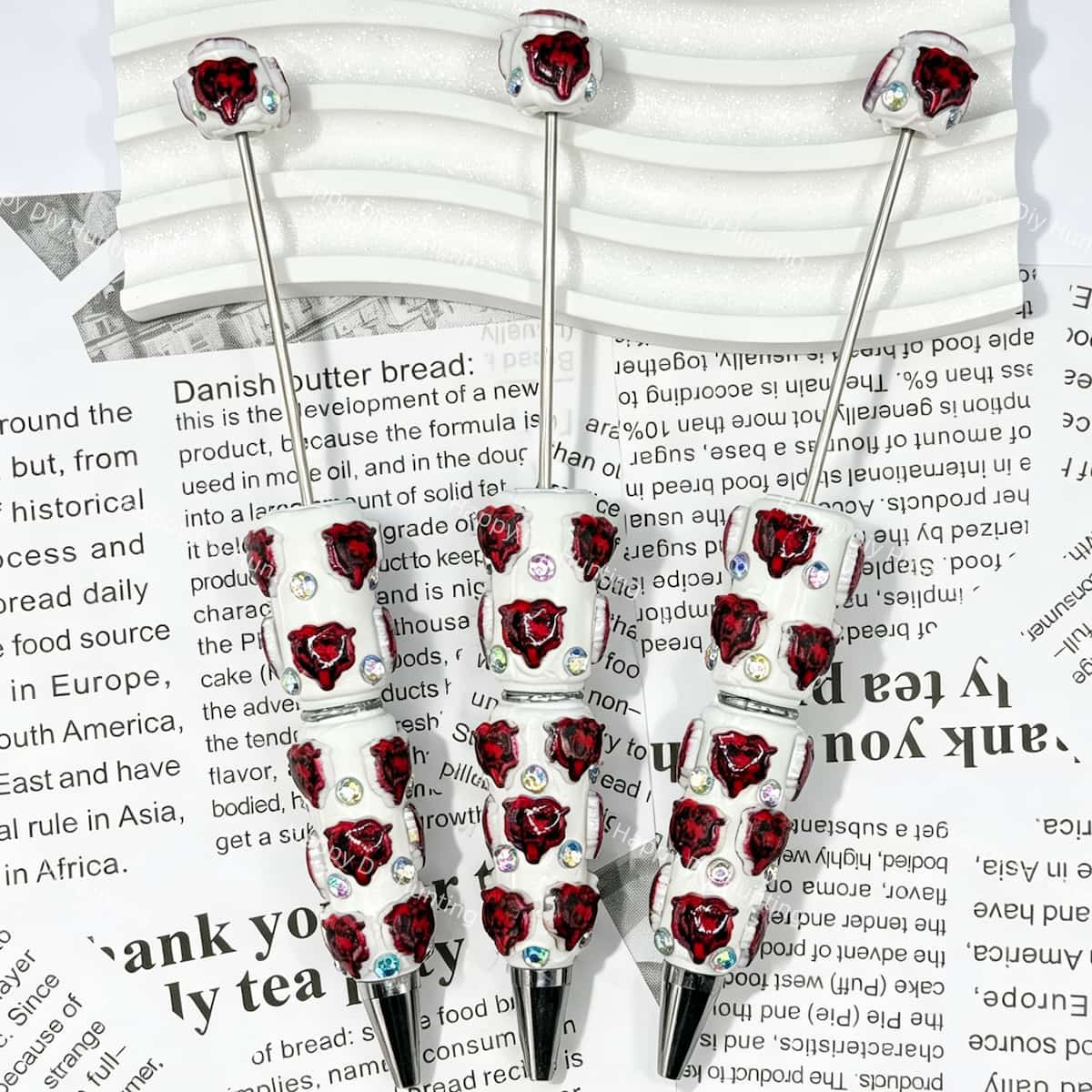 close-up red bear-head MSU college football beadable pen showing bear design and beadable barrel