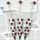 close-up red bear-head MSU college football beadable pen showing bear design and beadable barrel