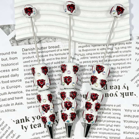 close-up red bear-head MSU college football beadable pen showing bear design and beadable barrel