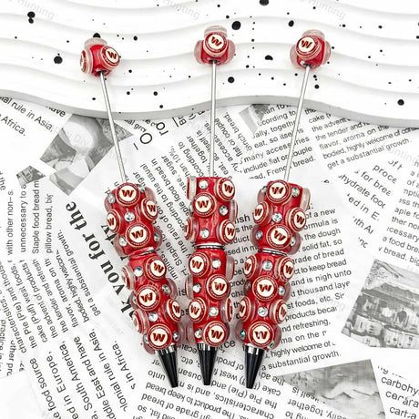 Red W‑letter football emblem sports beadable pens, circular beads printed with W‑letter patterns and iridescent rhinestones for diy handmade stationery
