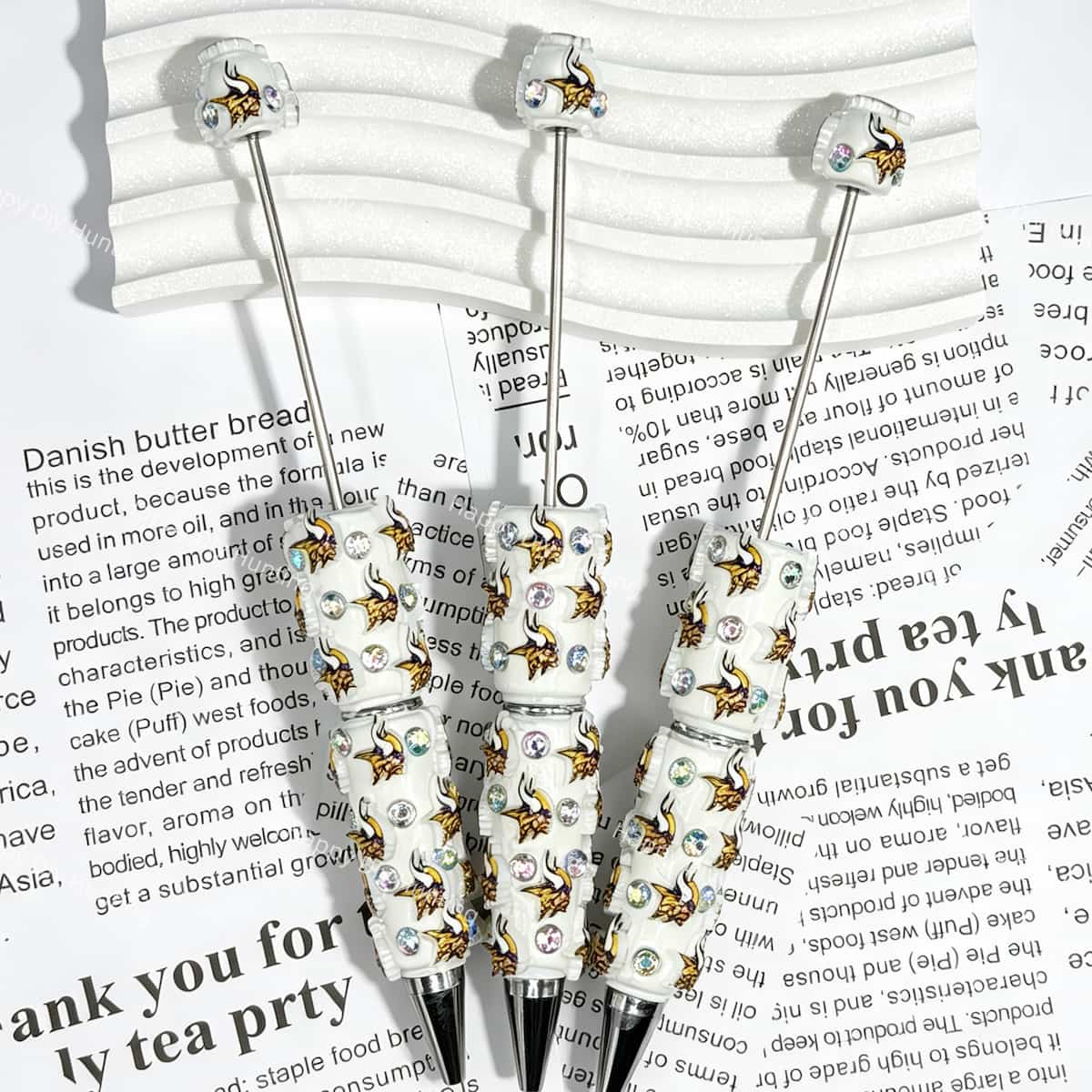 close-up white Norseman MV football beadable pen showing viking design and beadable barrel