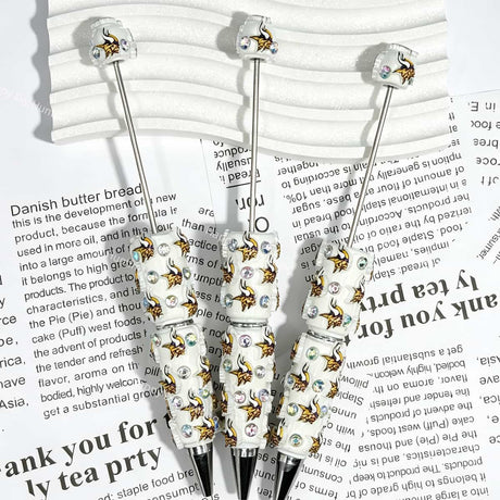 close-up white Norseman MV football beadable pen showing viking design and beadable barrel