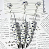 close-up white Seahawk bird SS football beadable pen showing seahawk design and beadable barrel