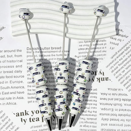 close-up white Seahawk bird SS football beadable pen showing seahawk design and beadable barrel
